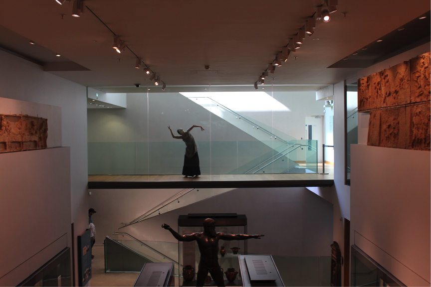 Photograph of Marie-Louise Crawley performing a solo, masked, dance piece at the Ashmolean Museum