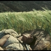 A screenshot from Pier Paolo Pasolini's film Edipo Re, showing Oedipus lying in a field.