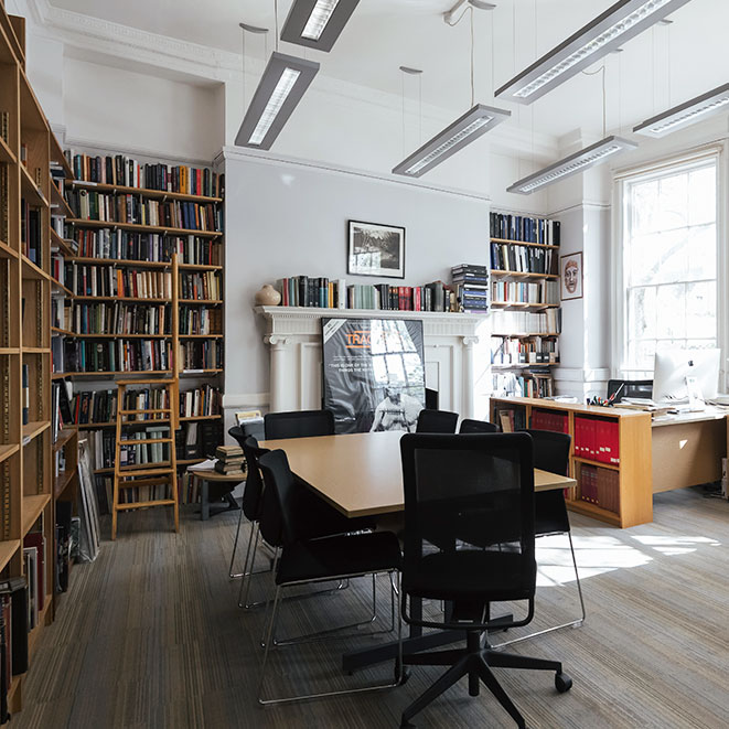 Photograph of the APGRD Study Room, showing bookshelves and meeting table with chairs.