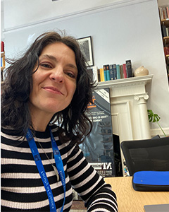 Picture of a brunette woman smiling in an office space