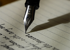Close up photograph of the nib a fountain pen writing a letter